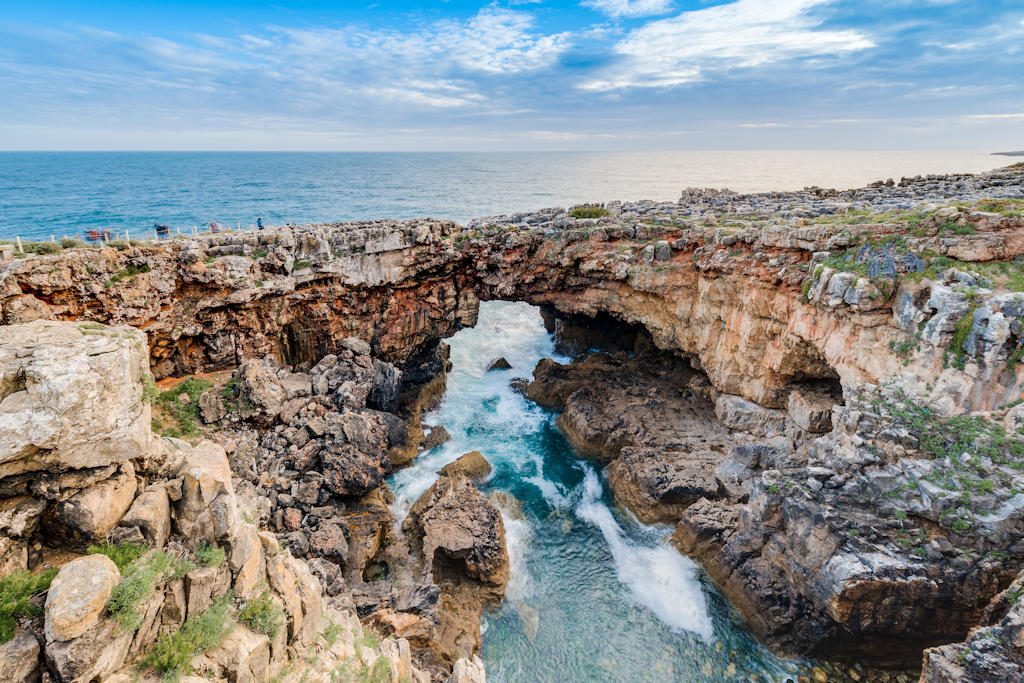 Witness the raw power and breathtaking beauty of Boca do Inferno, Cascais, as crashing waves sculpt dramatic coastal cliffs.