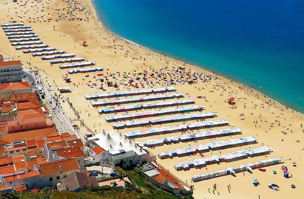 Experience the breathtaking beauty of Nazaré's beaches, where pristine sands meet thrilling waves, offering a perfect blend of relaxation and adventure.