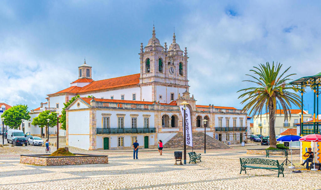 Experience the divine allure of the Sanctuary of Our Lady of Nazaré, a revered pilgrimage site in Portugal known for miracles and breathtaking views.