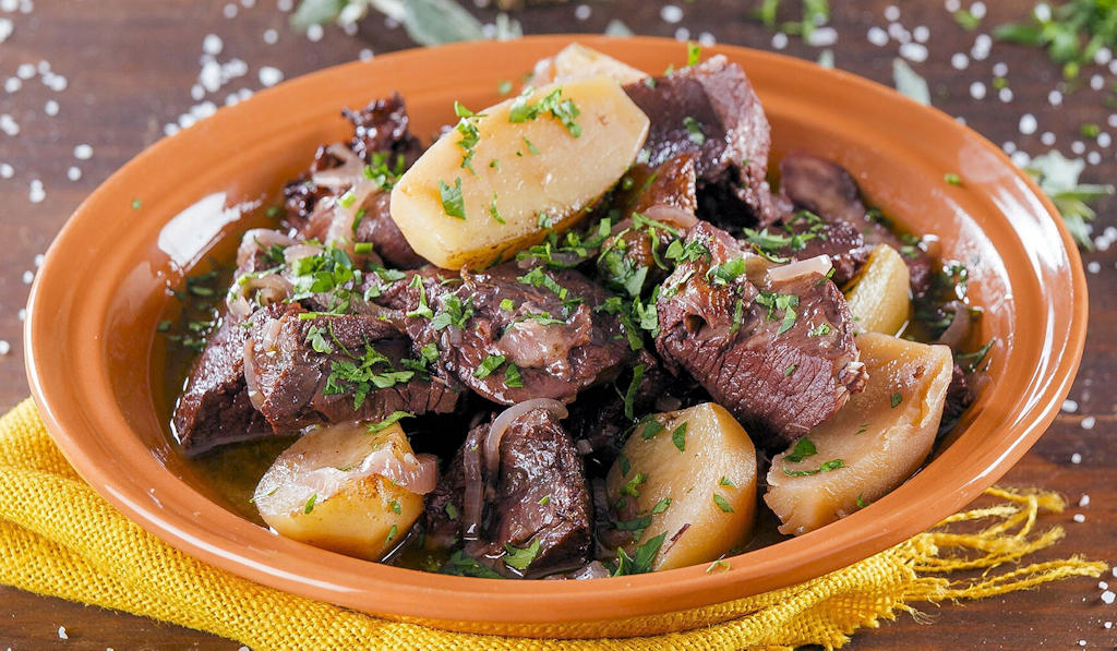 Chanfana: A delectable Portuguese stew with slow-cooked goat or lamb immersed in red wine and fragrant herbs, capturing the essence of Portugal's culinary heritage.