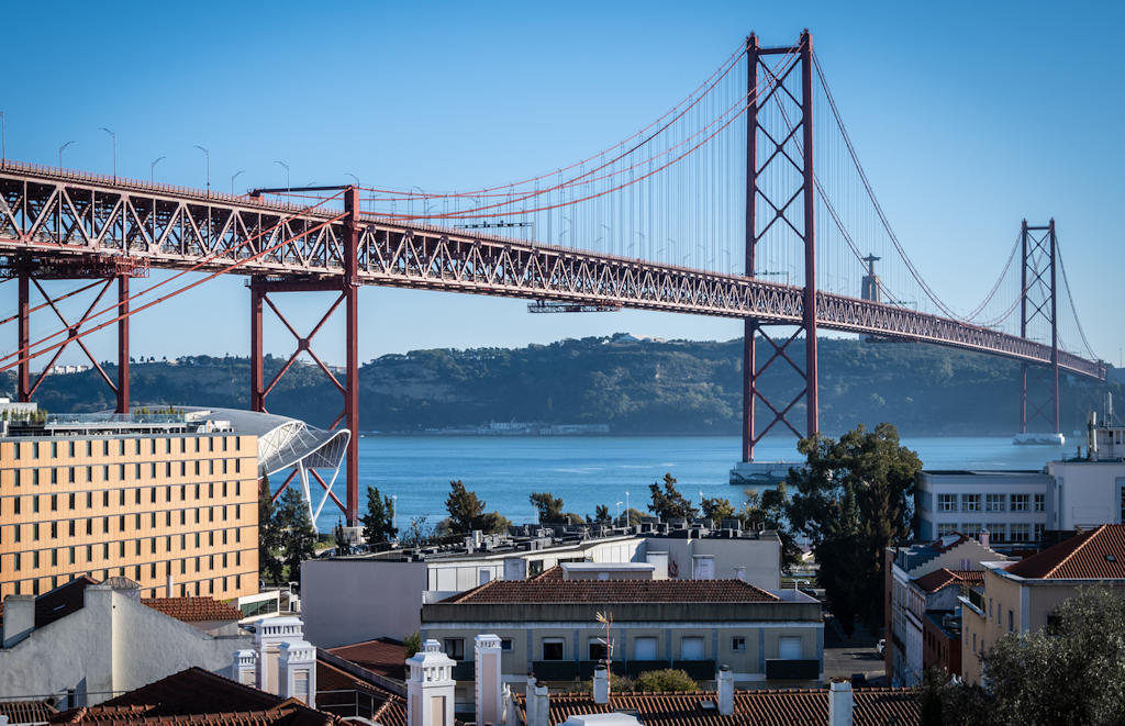 Experience the mesmerizing charm of Santo Amaro Viewpoint in Lisbon, offering enchanting views of the 25 de Abril Bridge and the serene Tejo River.